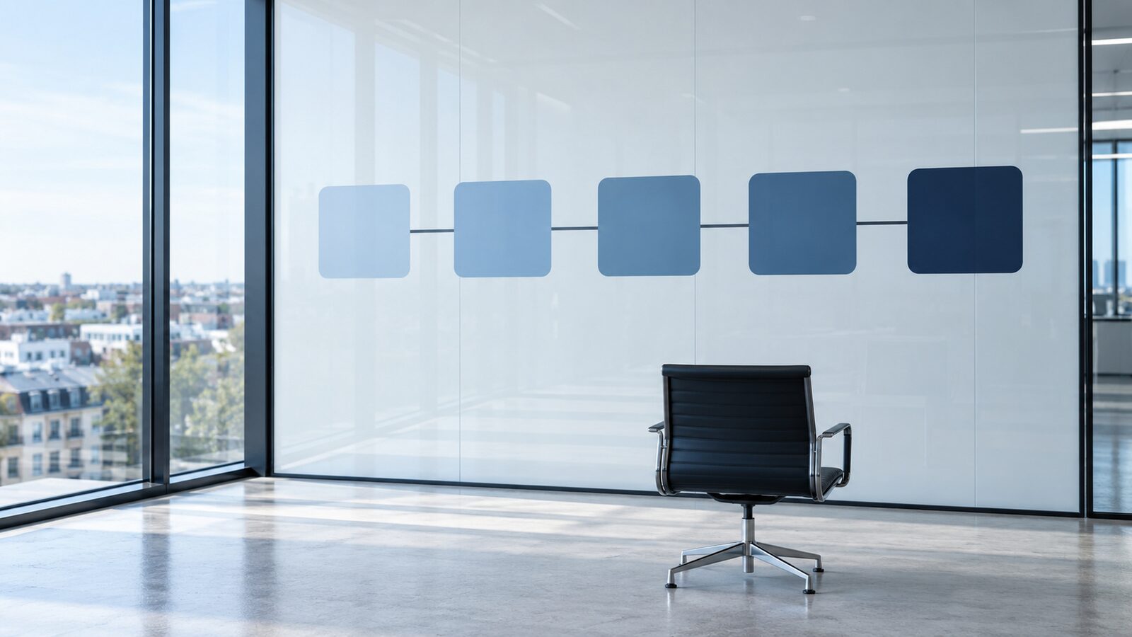 Five connected tiles in graded shades of blue on a white wall, an empty office chair in front.