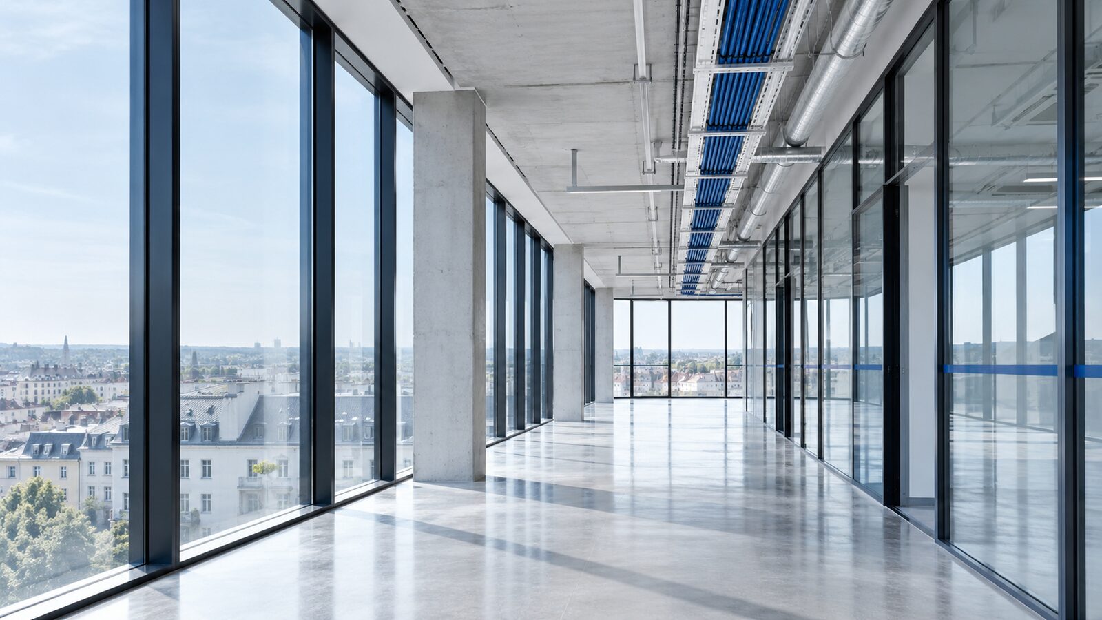 Shell construction floor with a glass front, a cable tray with blue lines on the ceiling.